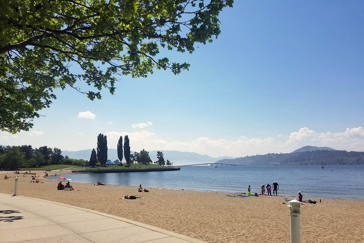 Tugboat Bay, a Kelowna beach with white sand along the Waterfront Promenade