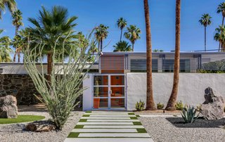 This updated 1957 home in the Twin Palms Estate features the subdivision’s signature palm trees front and center.