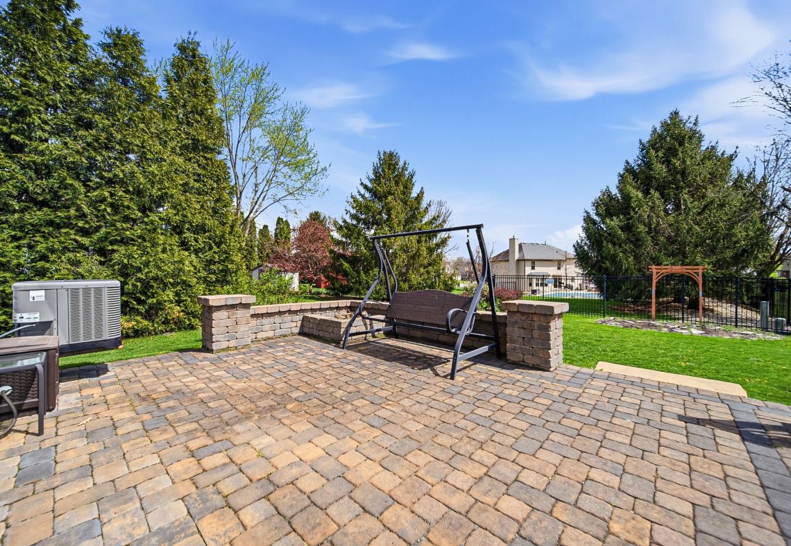 Paver patio with swing and landscaping