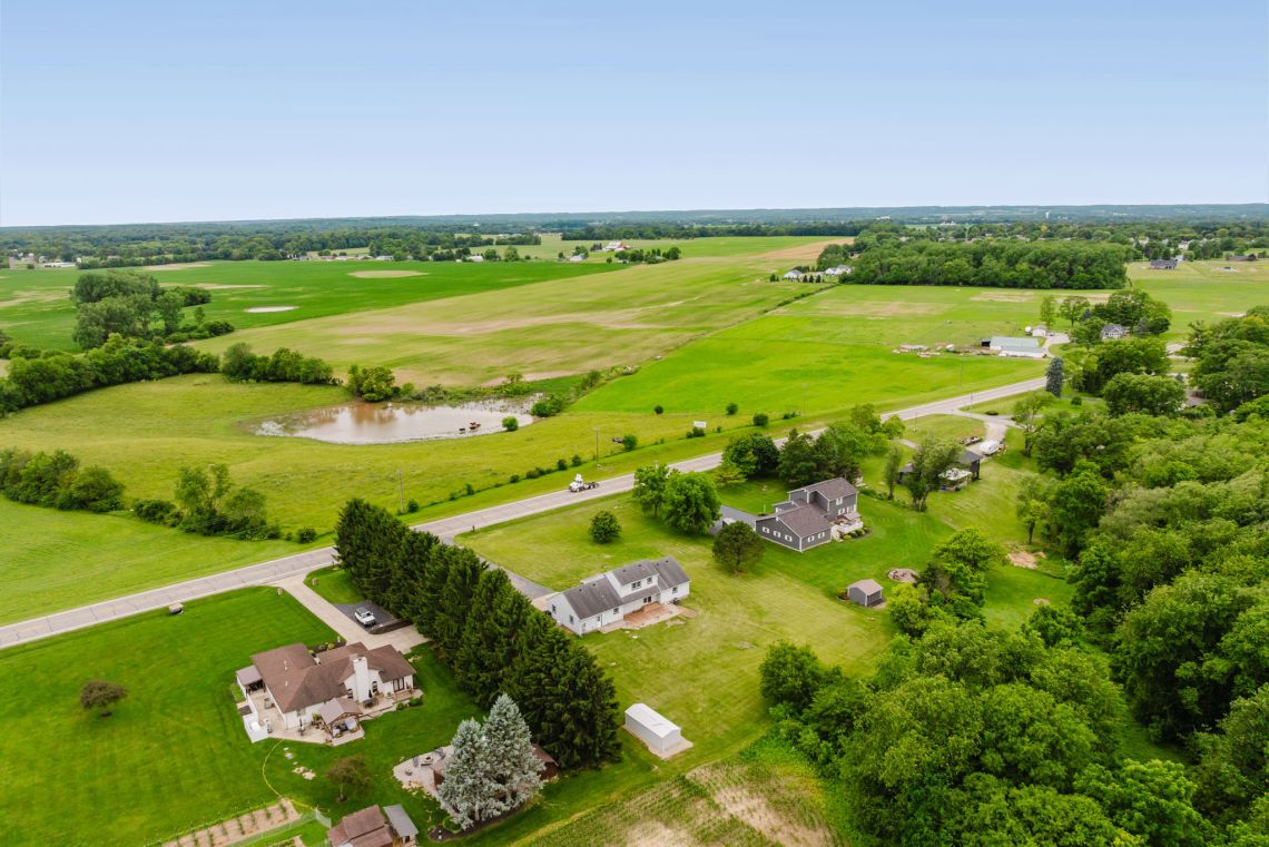 the pasture and cattle across the road