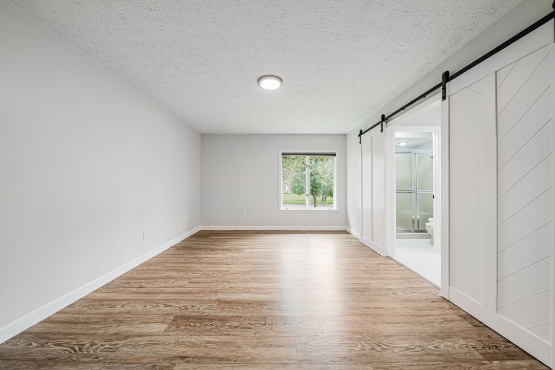 Primary bedroom with sliding barn door