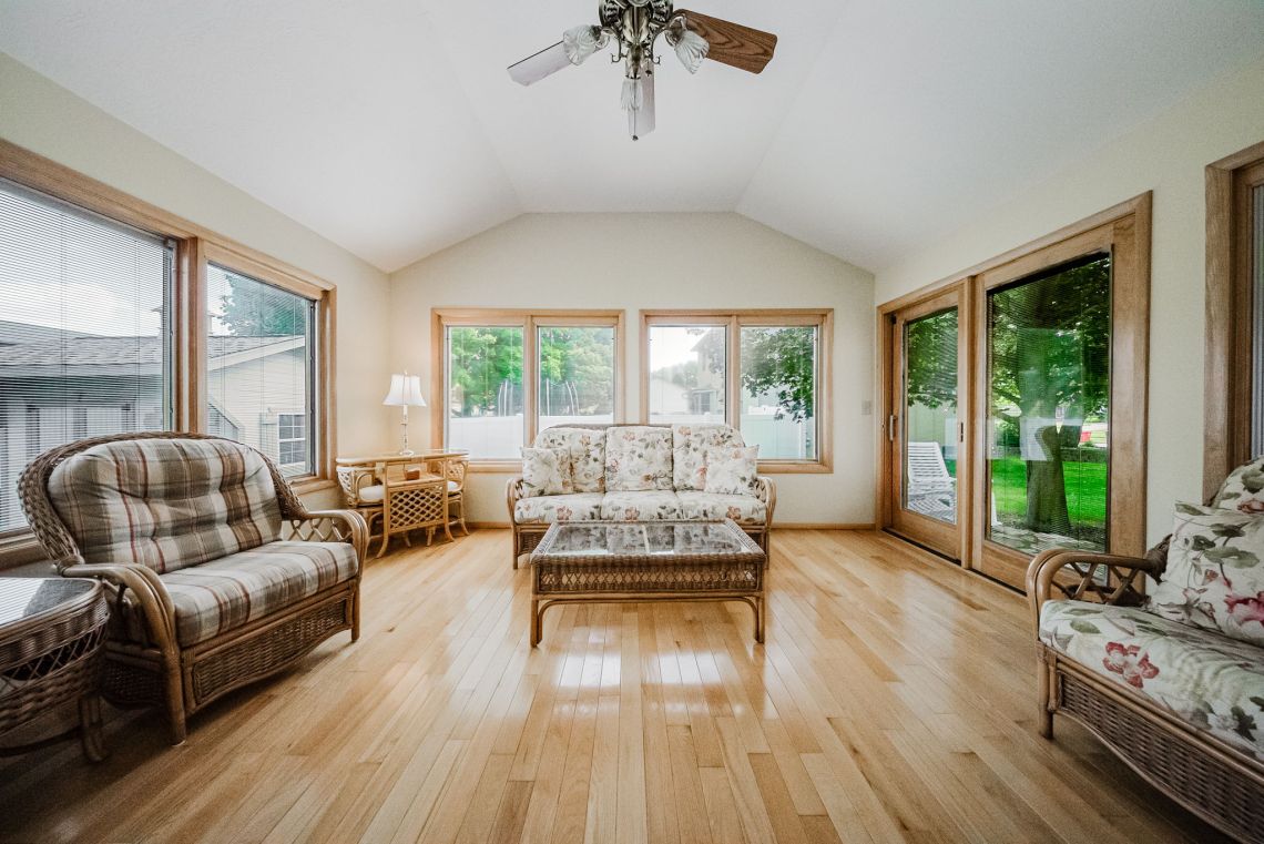 Vaulted four-season room wrapped in glass
