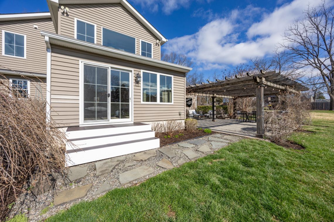 Back patio view with pergola and garden