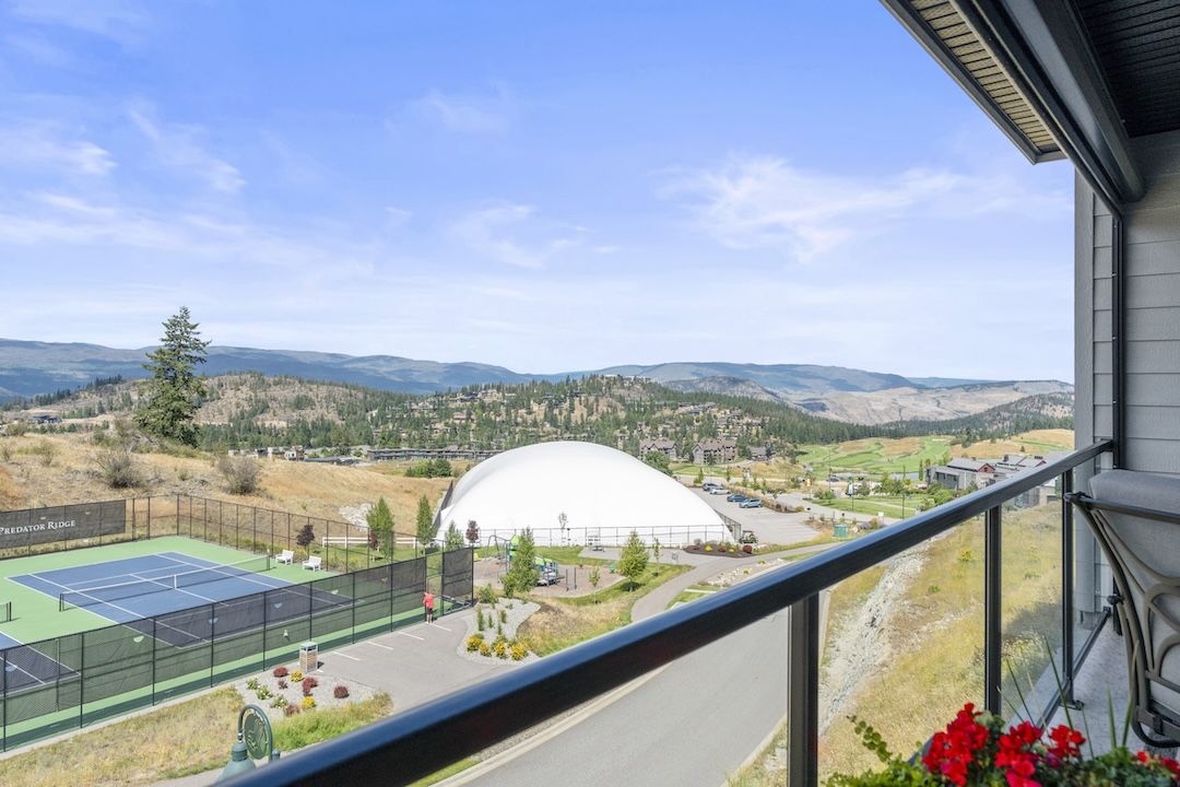 View from deck showing tennis courts dome and mountains