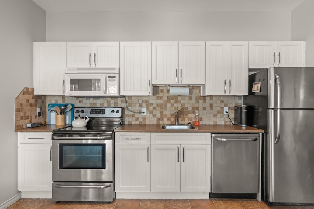 Kitchen with white cabinetry and Frigidaire appliances