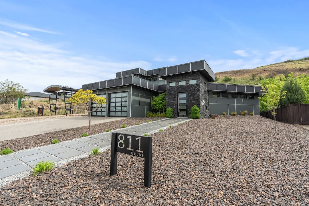 Front exterior showing the modern architecture against the hillside