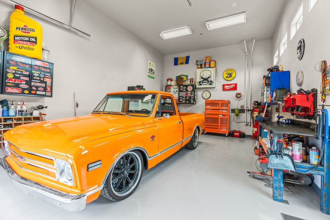 The shop with a vintage orange C10 truck inside