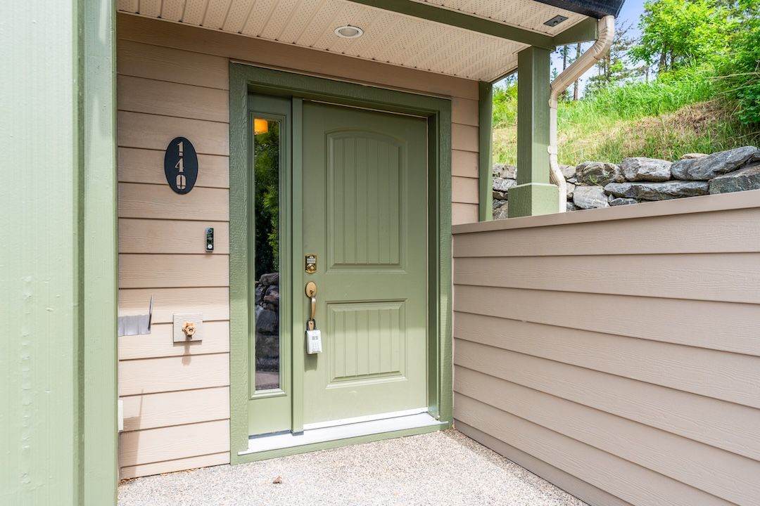 Front of the townhome with driveway and double garage doors