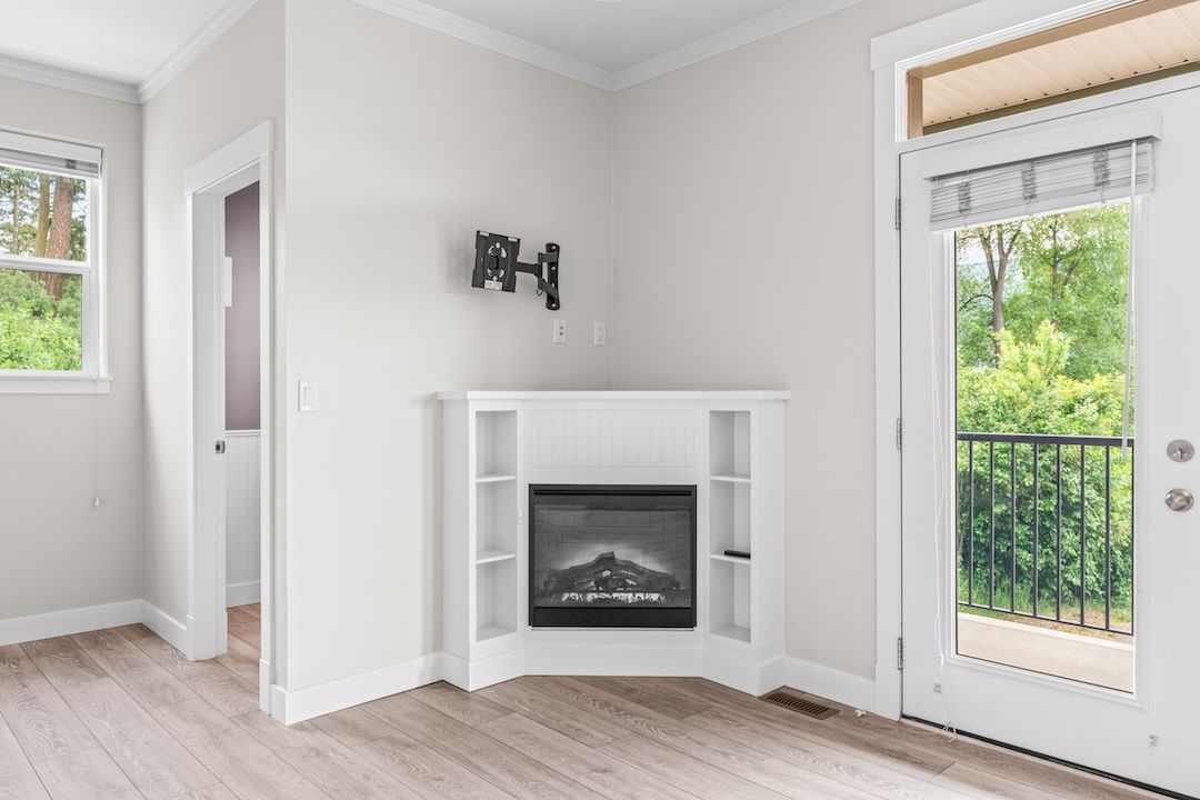 Living room with electric fireplace and open flow to the deck