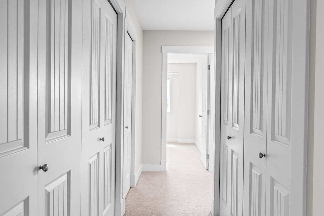 Top floor hallway connecting the primary suite and secondary bedrooms