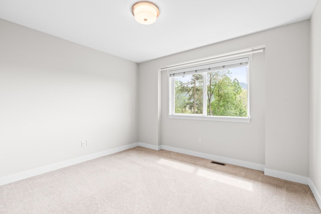 Vaulted primary bedroom on the top floor with walk-in closet and ensuite