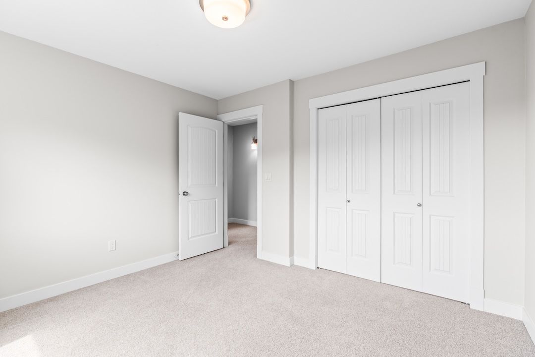 Primary walk-in closet with built-in shelving