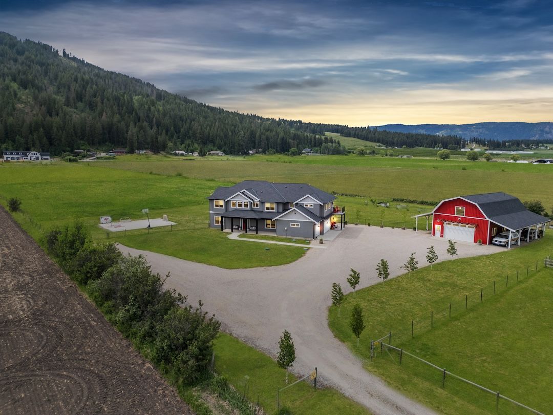 Twilight aerial of 4160 Noble Road showing the modern farmhouse, the shop, and the 4.5 acres