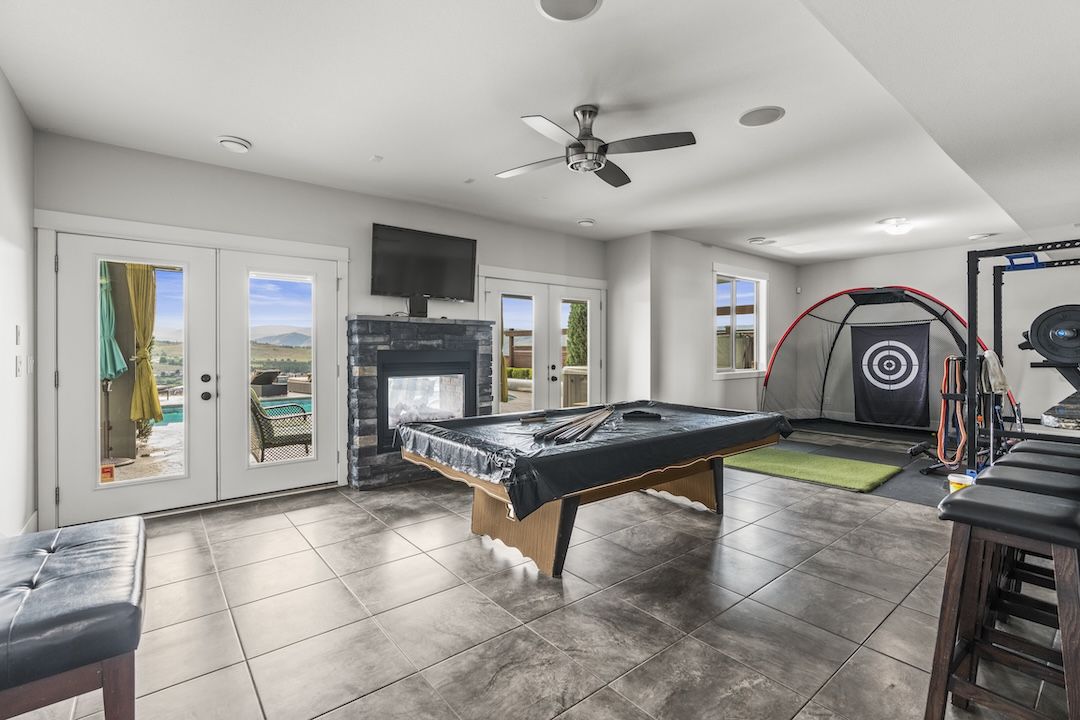 Games room with pool table and golf practice setup