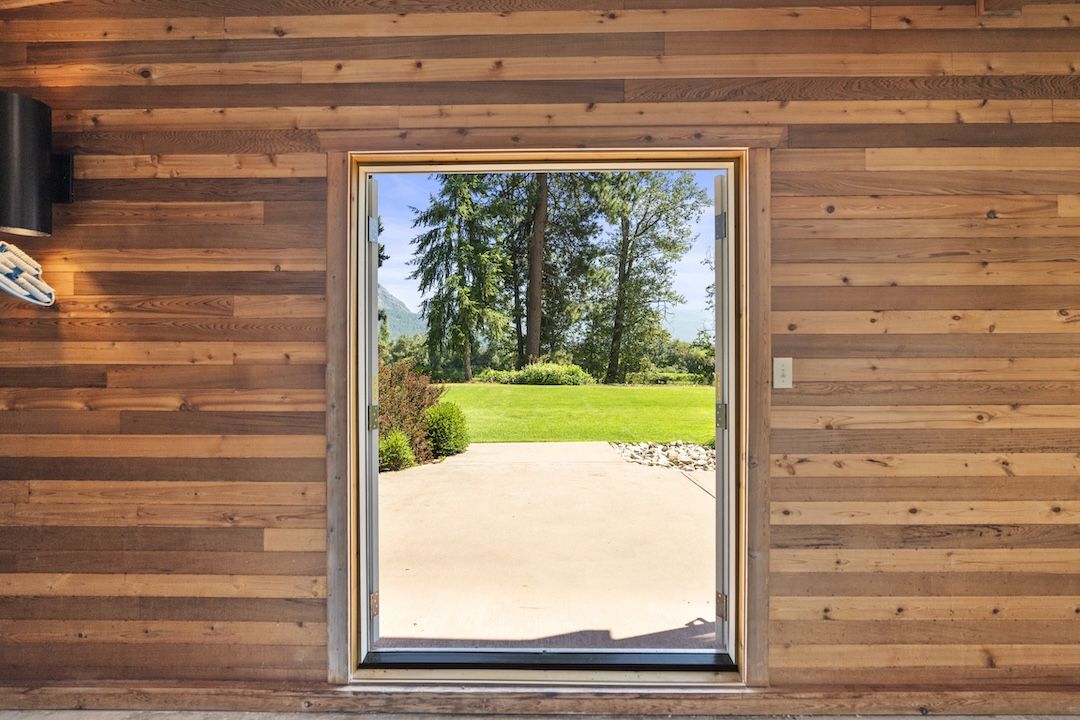 French doors open to the Shuswap River and Enderby Cliffs