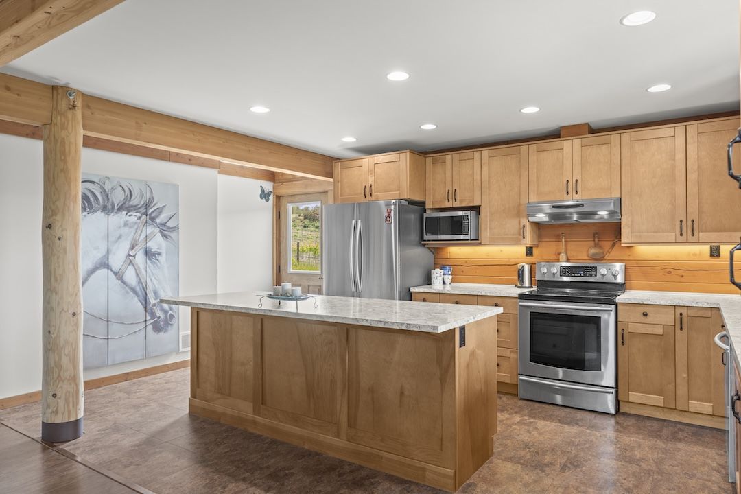 Maple kitchen with a large island at 9371 Highway 6, Coldstream BC