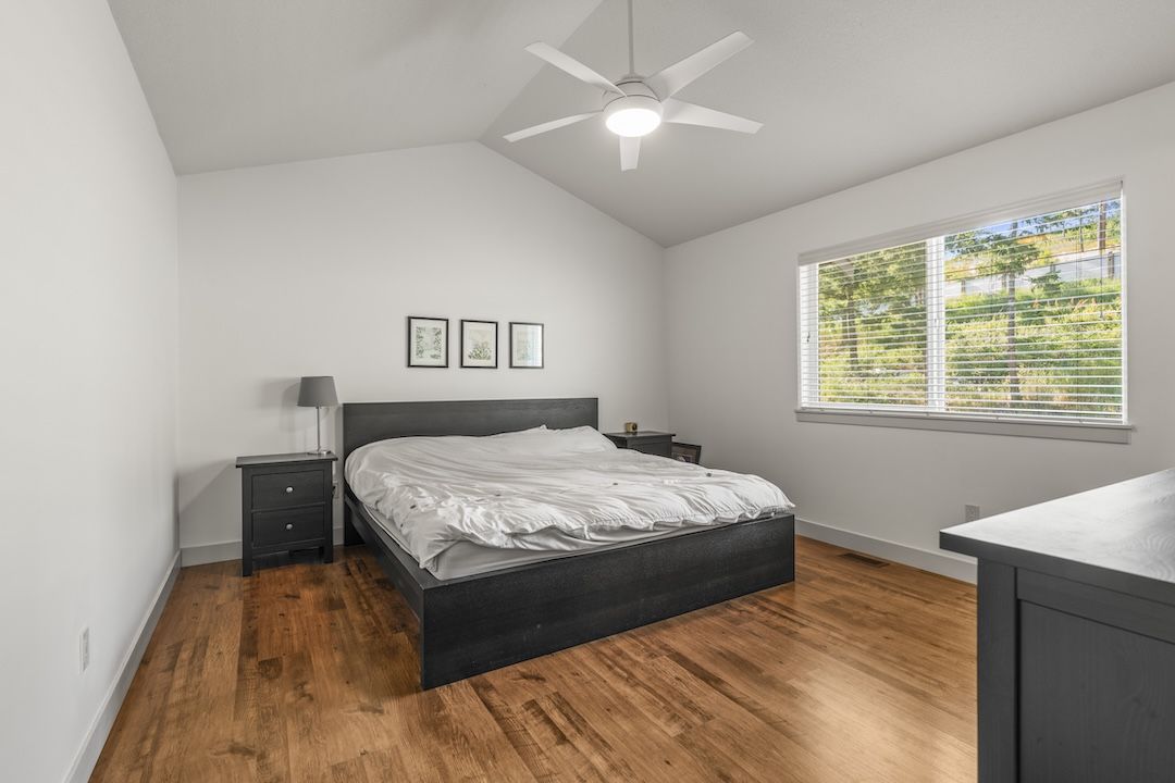 Primary bedroom with vaulted ceiling
