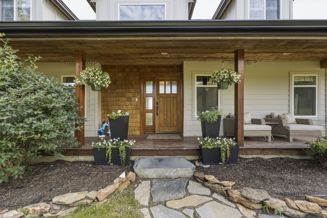 Front entrance with covered porch and planters