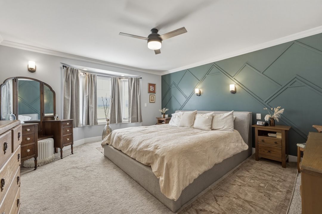 Main-floor primary bedroom with feature wall