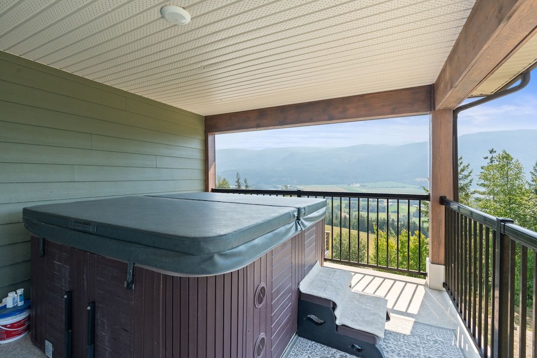 Private primary deck with hot tub overlooking the valley