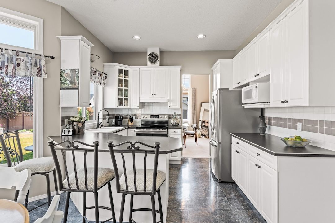 Kitchen with island and breakfast bar opening to the family room