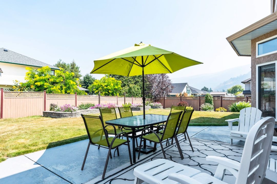 Patio with table and umbrella in the backyard