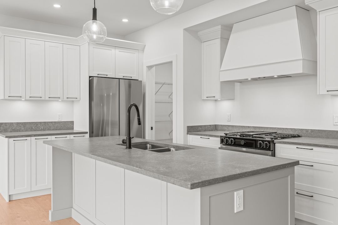 Kitchen with island and gas range in a similar Wesmont home
