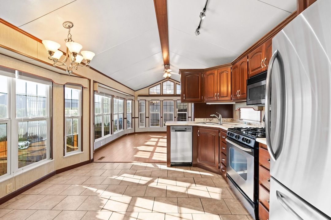 Kitchen and living room under a vaulted ceiling
