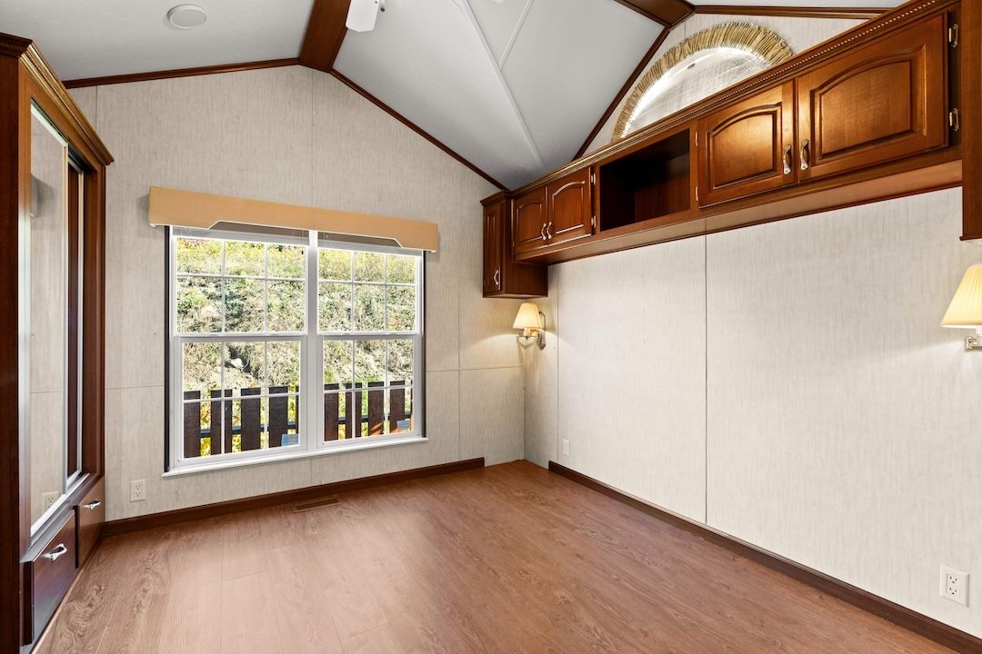 Bedroom with a large window and built-in storage