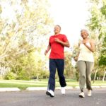 Older couple jogging outside