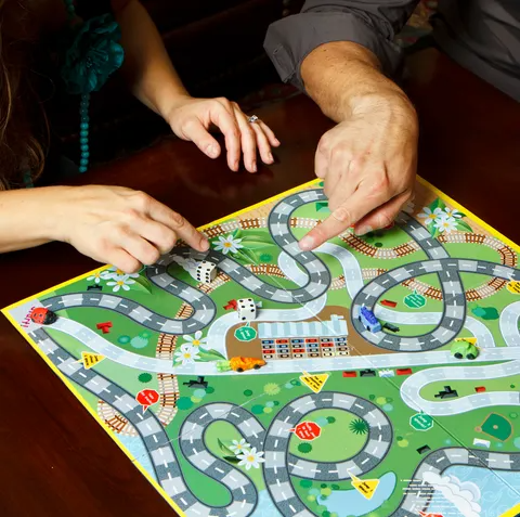 family playing board game