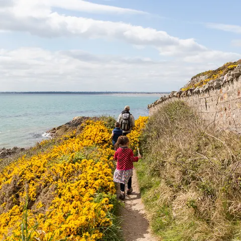 father and children hiking on a trail