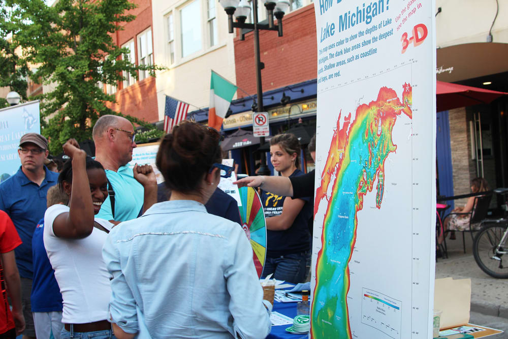 Ann Arbor Mayor's Green Fair-goers look at a map of Lake Michigan, 2017. Photo courtesy of NOAA GLERL.